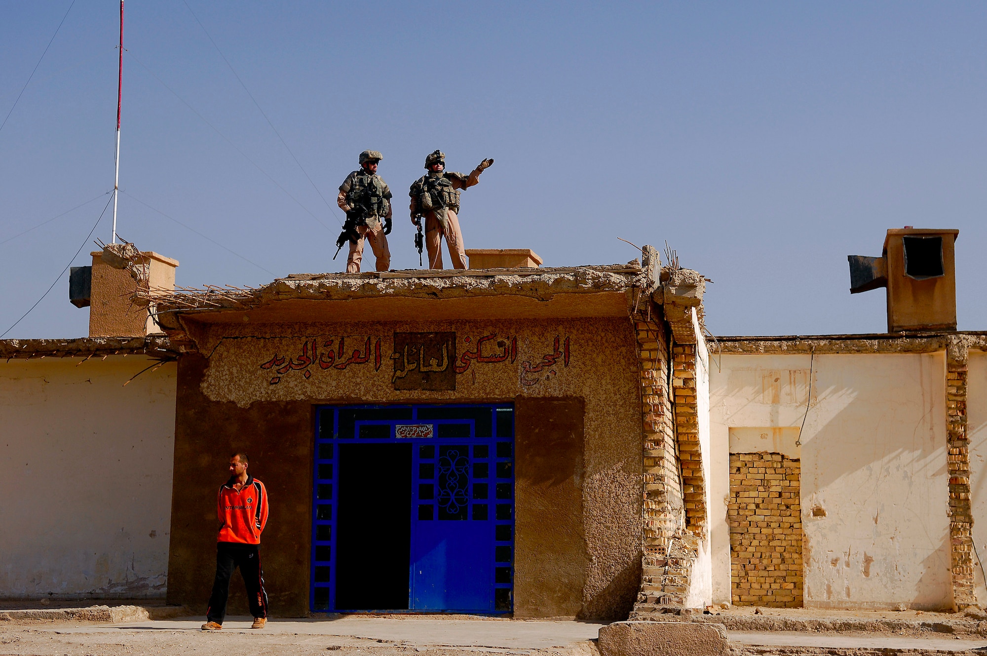 Master Sgt. William Schaal (left) and Tech Sgt. Terry Miller check the neighborhood around an Iraqi police station Mar. 3 in the southwest area of Baghdad, Iraq. The two sergeants are assigned to Detachment 3 of the 732nd Security Forces Squadron at Sather Air Base, Iraq. Sergeant Schaal is deployed from 341st Security Forces Squadron, Malmstrom Air Force Base, Mont., and Sergeant Miller is deployed from the 90th Security Forces Squadron, F.E. Warren AFB, Wyo.  (U.S. Air Force photo/Master Sgt. Andy Dunaway)