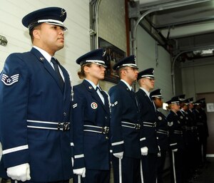 LANGLEY AIR FORCE BASE, Va. -- Langley's Honor Guard stands at attention during the graduation ceremony Feb. 21. Airmen who are interested in joining the honor guard must be E-1 to E-5 and can’t be on a medical waiver. During the ten day training, Airmen learn color guard, pall bearing, flag folding, firing parties and how to maintain military bearing and professionalism. (U.S. Air Force photo/Airman Gul Crockett)