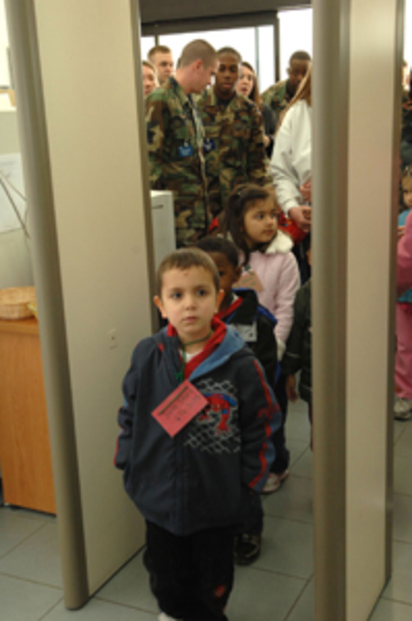 Incirlik Unit School pre-school students walk through the metal detector as part of the full transportation experience. The students took a field trip through the 39th Logistics Readiness Squadron's transportation department and the 728th Air Mobility Squadron passenger terminal Feb. 20 to learn how cargo and people are transported from place-to-place.