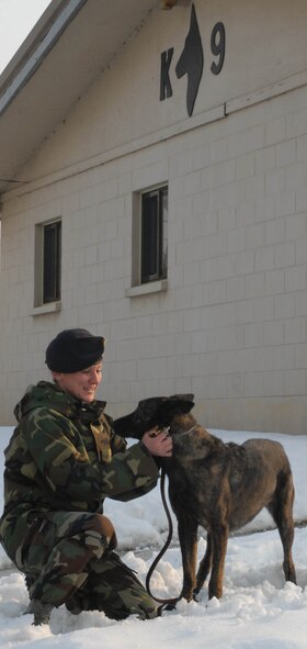 KUNSAN AIR BASE, South Korea -- Senior Airman Rachel Sarcia, 8th Security Forces Squadron military working dog handler, takes a break with her partner, Archie, at the military working dog facility here. March recognizes the accomplishments of women and their contributions to society.  (U.S. Air Force Photo/Senior Airman Steven R. Doty)                                