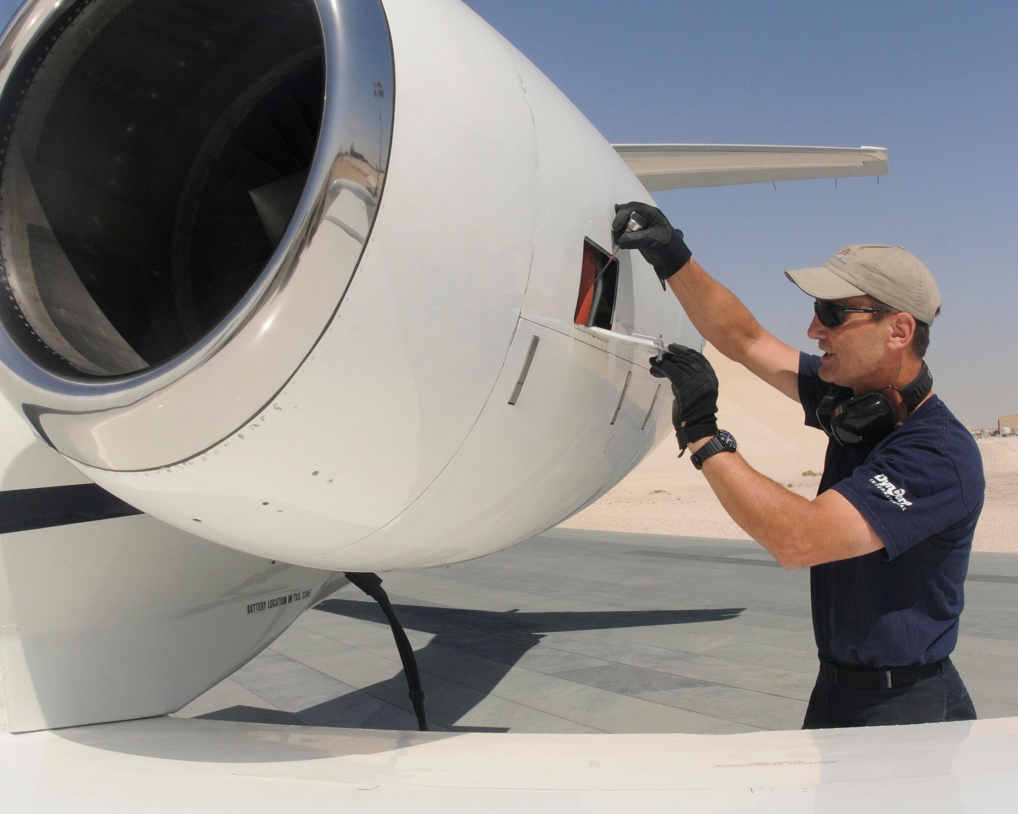 SOUTHWEST ASIA -- James Dial, a C-21 maintainer, checks the oil bypass detectors before a flight March 8. Mr. Dial voluntarily deployed here for a year from Peterson Air Force Base, Colo., in order to "serve those who serve." As a contractor, he is enjoying the experience and intends to extend his deployment. (U.S. Air Force photo/Senior Airman Domonique Simmons)