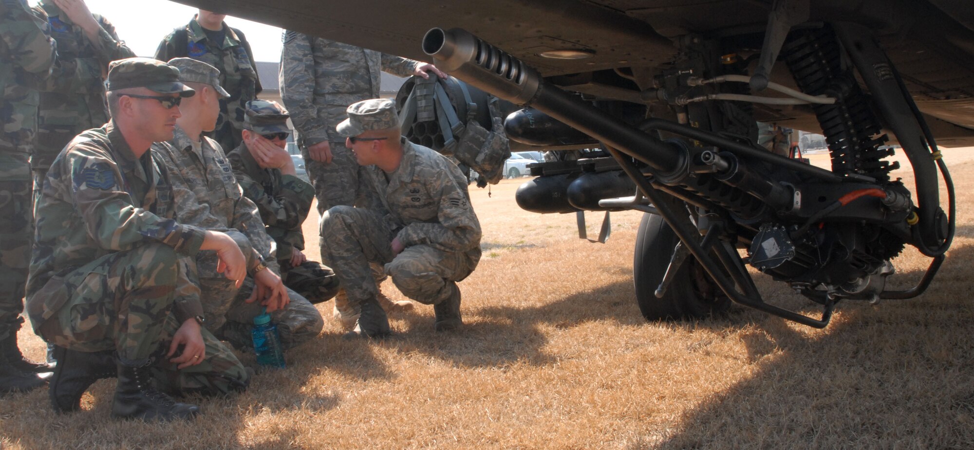 KUNSAN AIR BASE, Republic of Korea -- Technical Sergeant Steven Coppock (left), 8th Civil Engineer Squadron, Explosive Ordnance Disposal and fellow EOD members review the weapons on the AH-64D Apache helicopter from Charlie Company, 4-2 Attack Battalion, 2nd Combat Aviation Brigade, Camp Humphreys during a static display of the aircraft here Mar. 10.  The event was designed to inform Airmen about the aircraft and the Army's current mission here.  (U.S. Air Force photo/Staff Sgt. Darcie Ibidapo)