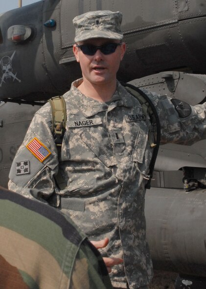 KUNSAN AIR BASE, Republic of Korea -- Chief Warrant Officer 3rd Class Pat Nager, a standardization instructor pilot with Charlie Company, 4-2 Attack Battalion, 2nd Combat Aviation Brigade from Camp Humphreys answers questions about the AH-64D Apache helicopter during a static display of the aircraft here Mar. 10.  The event was designed to inform Airmen about the aircraft and the Army's current mission here.  (U.S. Air Force photo/Staff Sgt. Darcie Ibidapo)