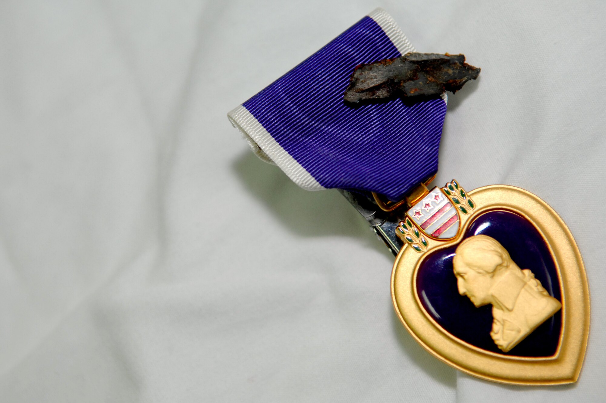 BALAD AIR BASE, Iraq -- A Purple Heart is reserved for U.S. servicemembers injured in a time of war. Capt. Adrian Barcus, 332nd Expeditionary Medical Operations Squadron intensive care unit staff physician, was hit by shrapnel outside of the Air Force Theater Hospital and was awarded the Purple Heart here, March 7. 