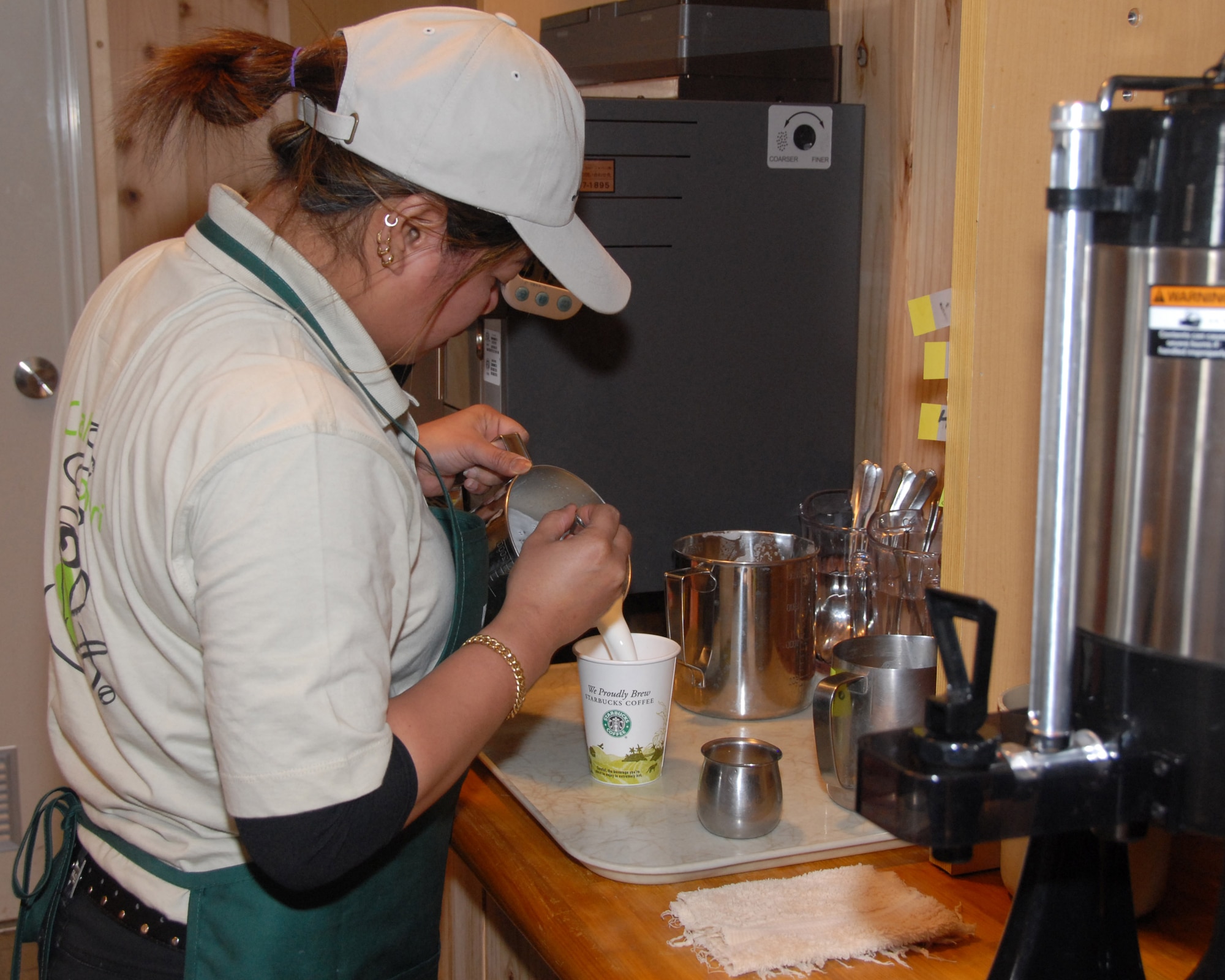 MISAWA AIR BASE, Japan -- Christina Thornton, wait staff member at Cafe Aomori, makes an espresso for a customer March 7. The cafe plans to increase their food selection by adding a donut machine and a line of desserts from a restaurant chain. (U.S. Air Force photo by Staff Sgt. Rachel Martinez)