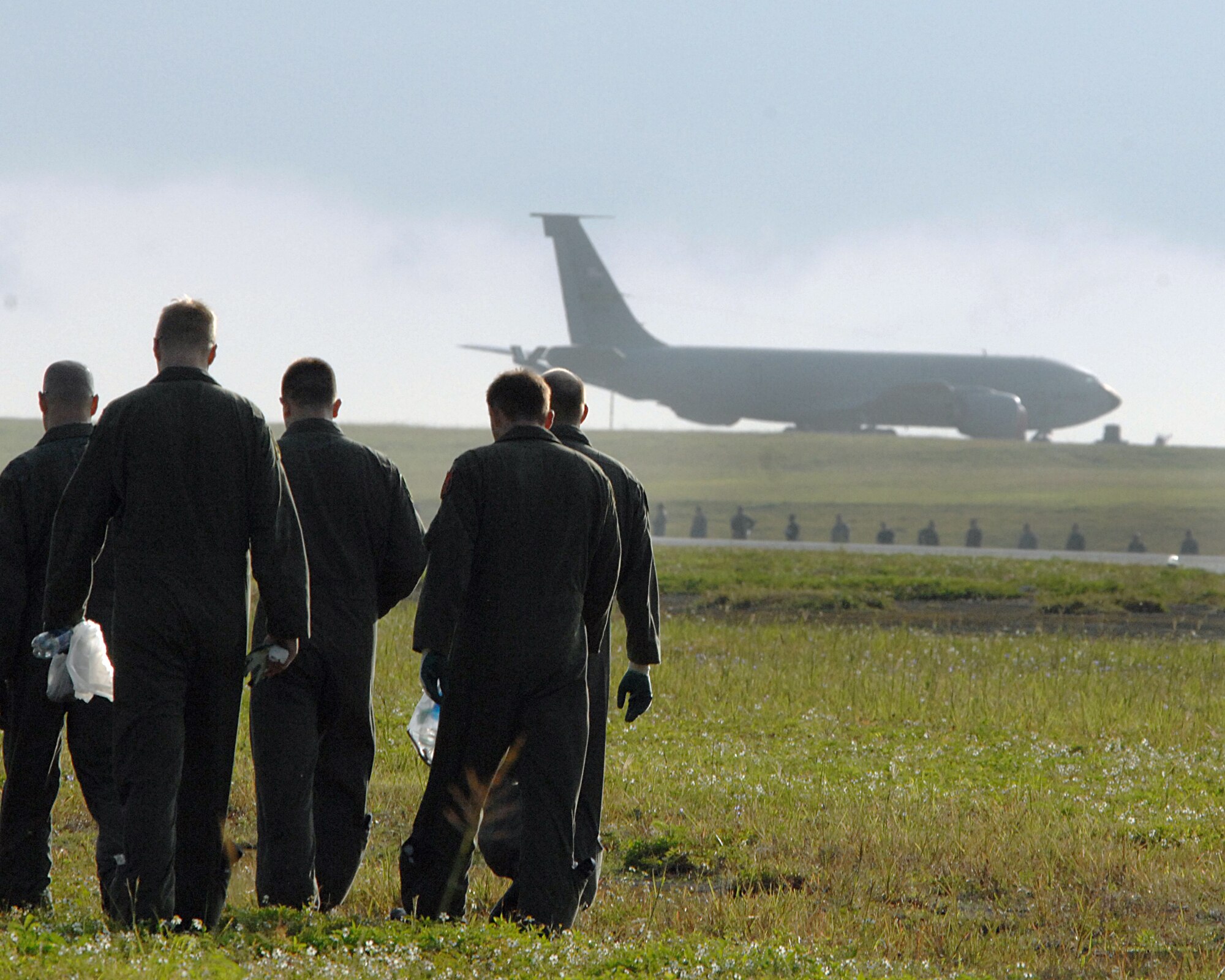 ANDERSEN AFB, Guam-- Members of the 96th Expeditionary Bomb Squadron and Andersen's 36th Wing scan the airfield for foreign object debris, or FOD. Andersen is clearing the airfield to re-open a runway that has been closed since a B-2 bomber crashed here. The 96th EBS is deployed here from Barksdale AFB, La. (U.S. Air Force Photo by Staff Sgt. Vanessa Valentine) 
