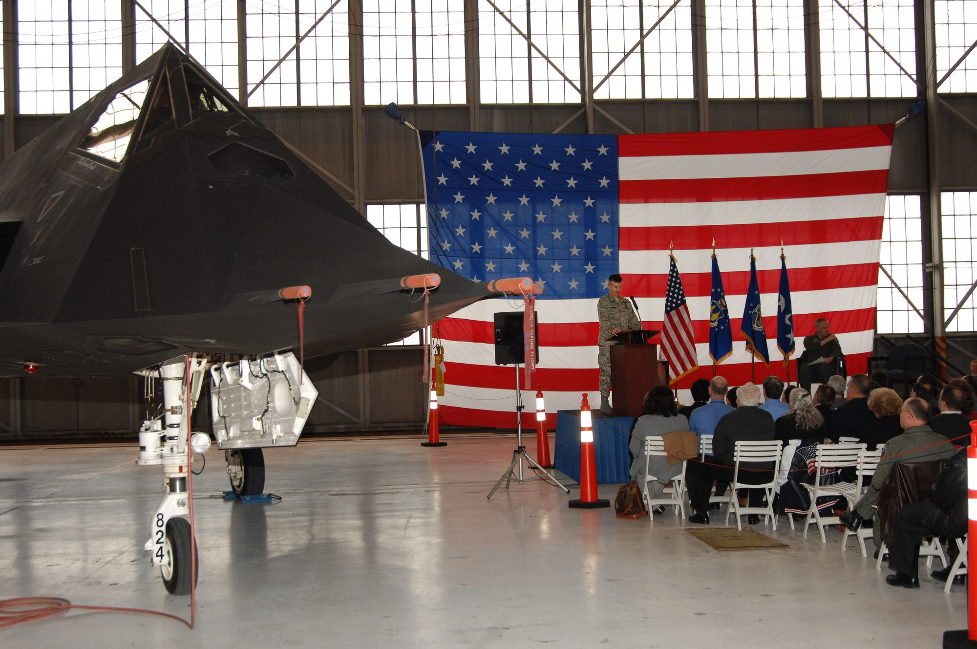 Col. Robert Stambaugh, commander of the 312/326th Aeronautical Systems Wing, speaks during a ceremony at Wright-Patterson Air Force Base honoring the legacy of the F-117A Nighthawk fleet.  The world's first stealth fighter is being retired to free up funding to help modernize the Air Force.  (U.S. Air Force photo by Ben Strasser)