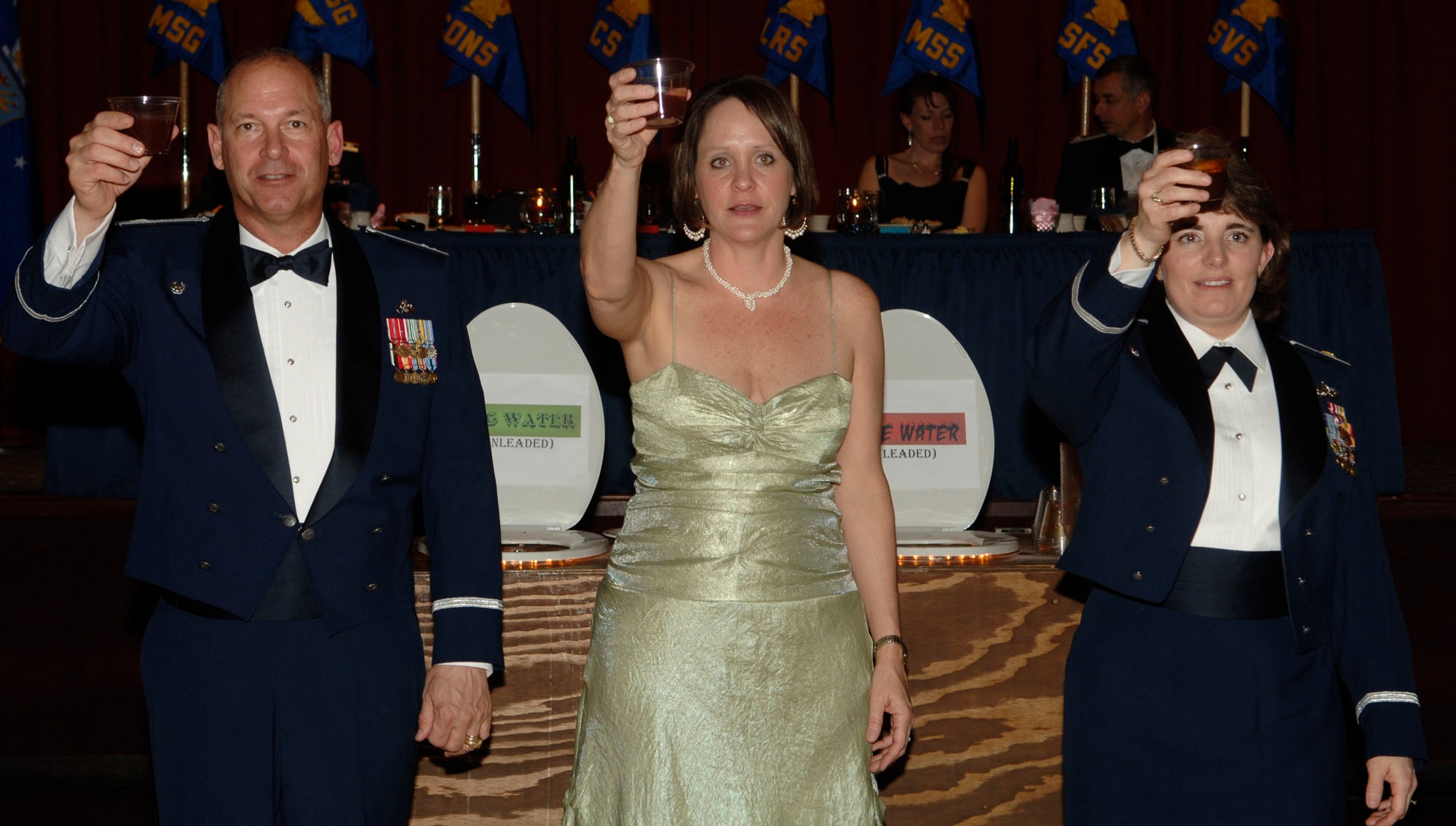 FAIRCHILD AIR FORCE BASE, Wash. – Col. Van Fuller, 92nd Mission Support Group commander, and his wife, Kelly Fuller, along with Maj. Pamela Woolley, 92nd Communications Squadron commander, toast the mess during the 92nd MSG dining out at Club Fairchild March 7. Individuals who violated rules of the mess were required to follow a set of procedures, which included toasting the mess with a drink from the grog bowl. (U.S. Air Force photo/Senior Chad Watkins)