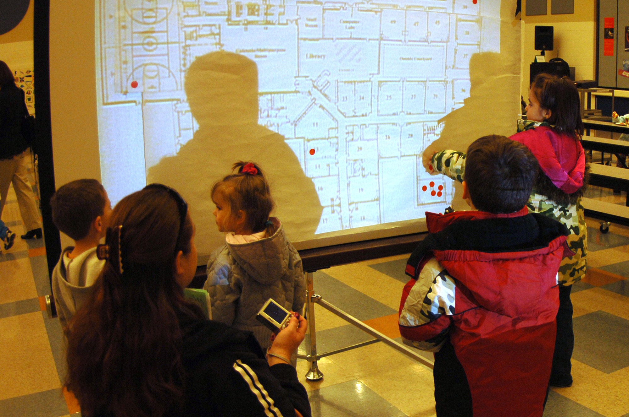 FAIRCHILD AIR FORCE BASE, Wash. – Children and parents gather to find the mapped location of their classroom during Family Night at Michael Anderson Elementary March 6. Family night consisted of games, activities and snacks, and ran in conjunction with the school’s Book Fair. (U.S. Air Force photo/Senior Airman Jocelyn Ford)
