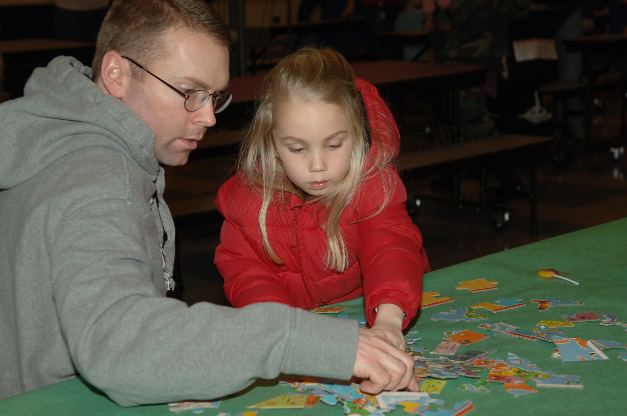 FAICHILD AIR FORCE BASE, Wash. – Tech. Sgt. Michael Darvis, 36th Rescue Flight, helps his daughter Megan with a puzzle during Family Night at Michael Anderson Elementary March 6. Other activities available to the families included a treasure hunt and coloring. (U.S. Air Force photo/Senior Airman Jocelyn Ford)