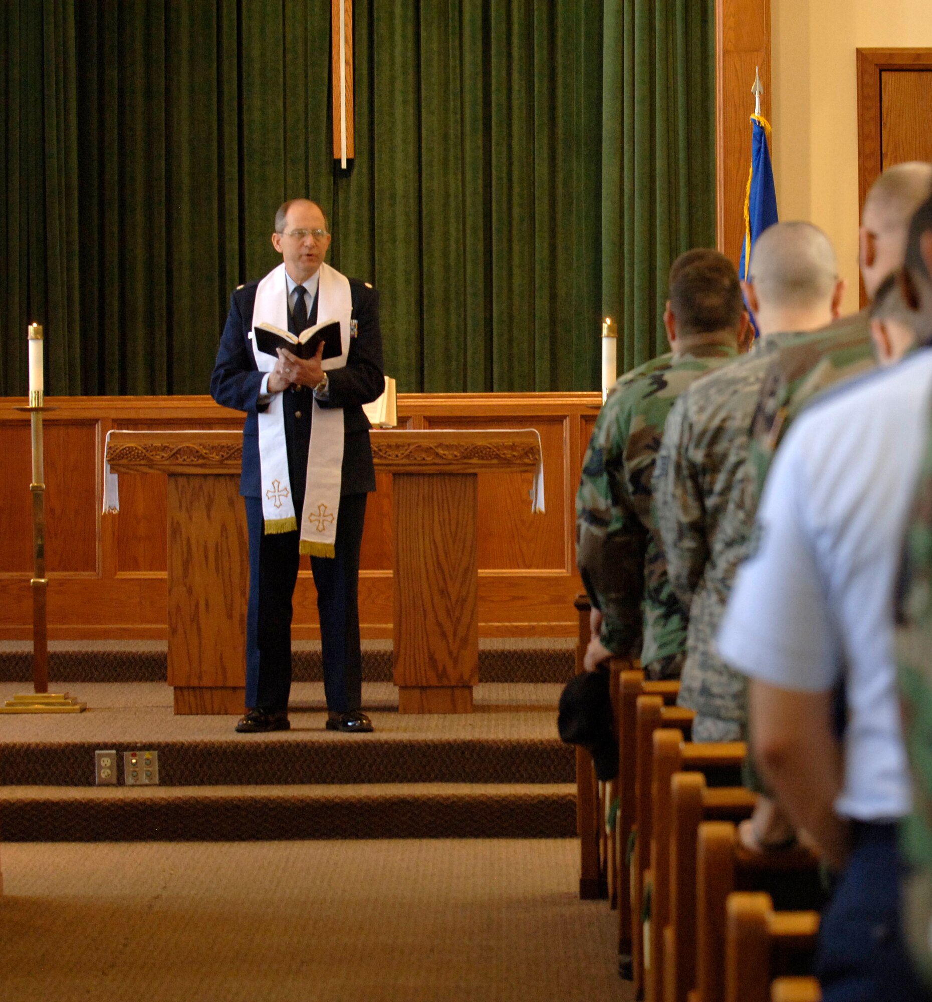 MCCONNELL AIR FORCE BASE, Kan. -- Chaplain (Lt. Col.) Michael Williams leads Team McConnell members in prayer at a memorial service held at the base chapel March 10, honoring Senior Airman Blake Perry. Airman Perry, 22nd Aircraft Maintenance Squadron, passed away Feb. 24 while on leave in Texas. Among those in attendance was his mother, Natalie Perry, and Father, John Perry. (photo by Airman 1st Class Laura Suttles)