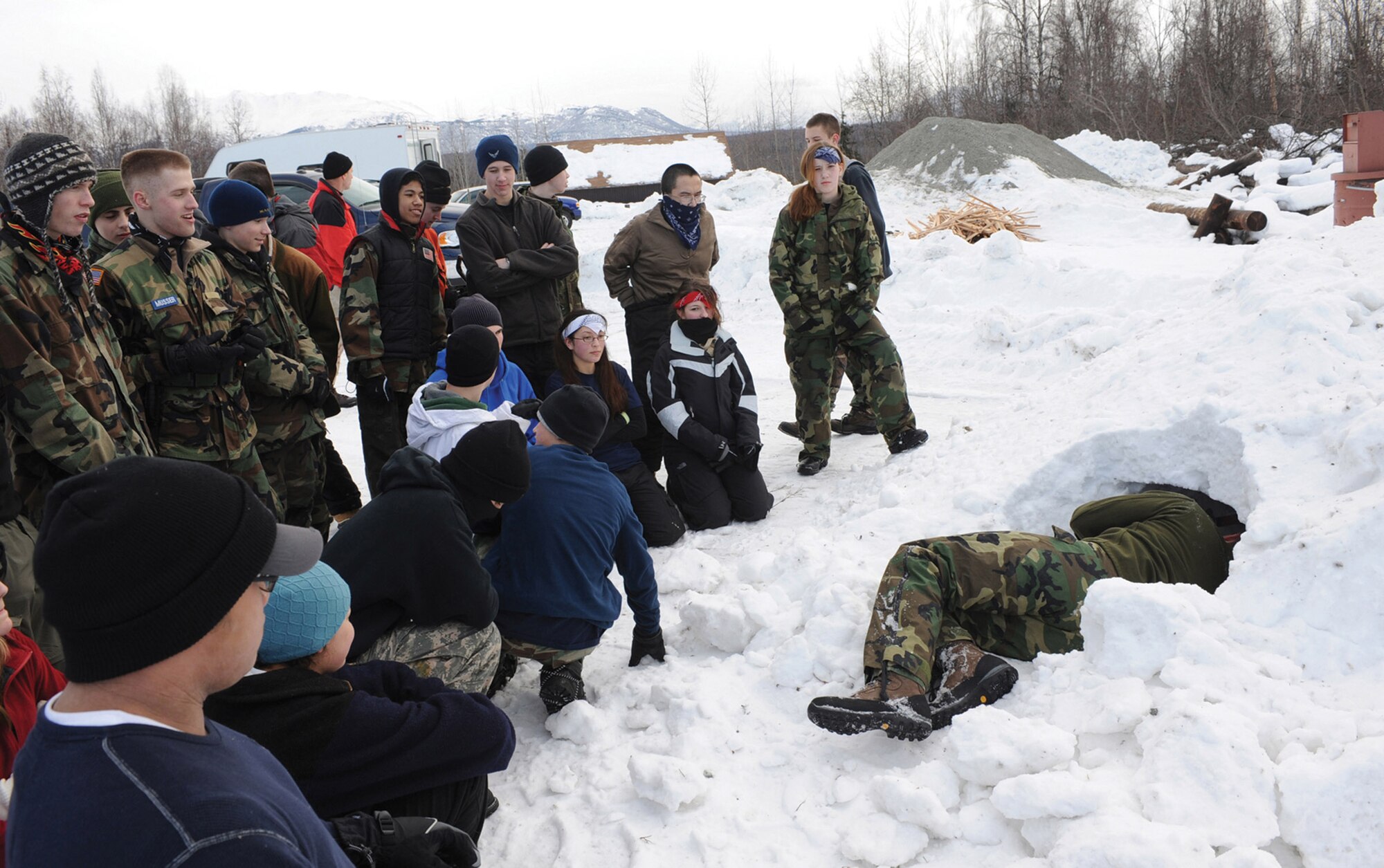 Staff Sgt. Marc Richard instructs Junior ROTC cadets from Eagle River and West High Schools on how to build a snow shelter Feb. 29 near Upper Otter Lake in Alaska. Sergeant Richard explained the technique of safely building a snow shelter during extreme cold weather. Sergeant Richard is with Det. 1of the 353rd Combat Training Squadron. (U.S. Air Force photo/Airman 1st Class Matt Owens) 