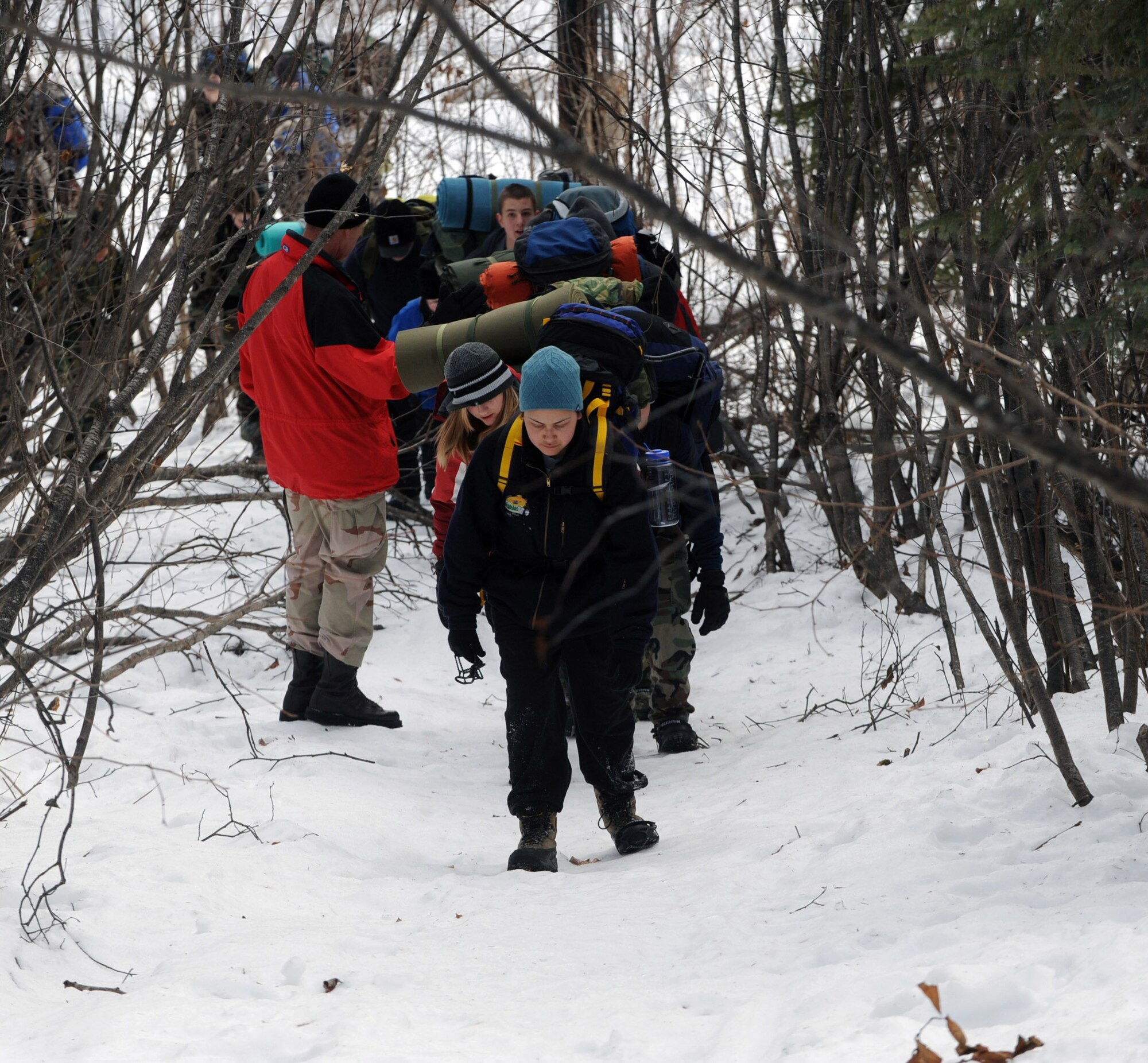 Cadets of the Eagle River and West High School Junior ROTC march the eight-mile trail Feb. 29 from the Fort Richardson Military Youth Academy to Upper Otter Lake in Alaska. Several cadets carried more than 50 pounds of gear on their back during the hike to the lake. Airmen from Elmendorf Air Force Base, Alaska, taught survivial training skills to the cadets. (U.S. Air Force photo/Airman 1st Class Matt Owens) 