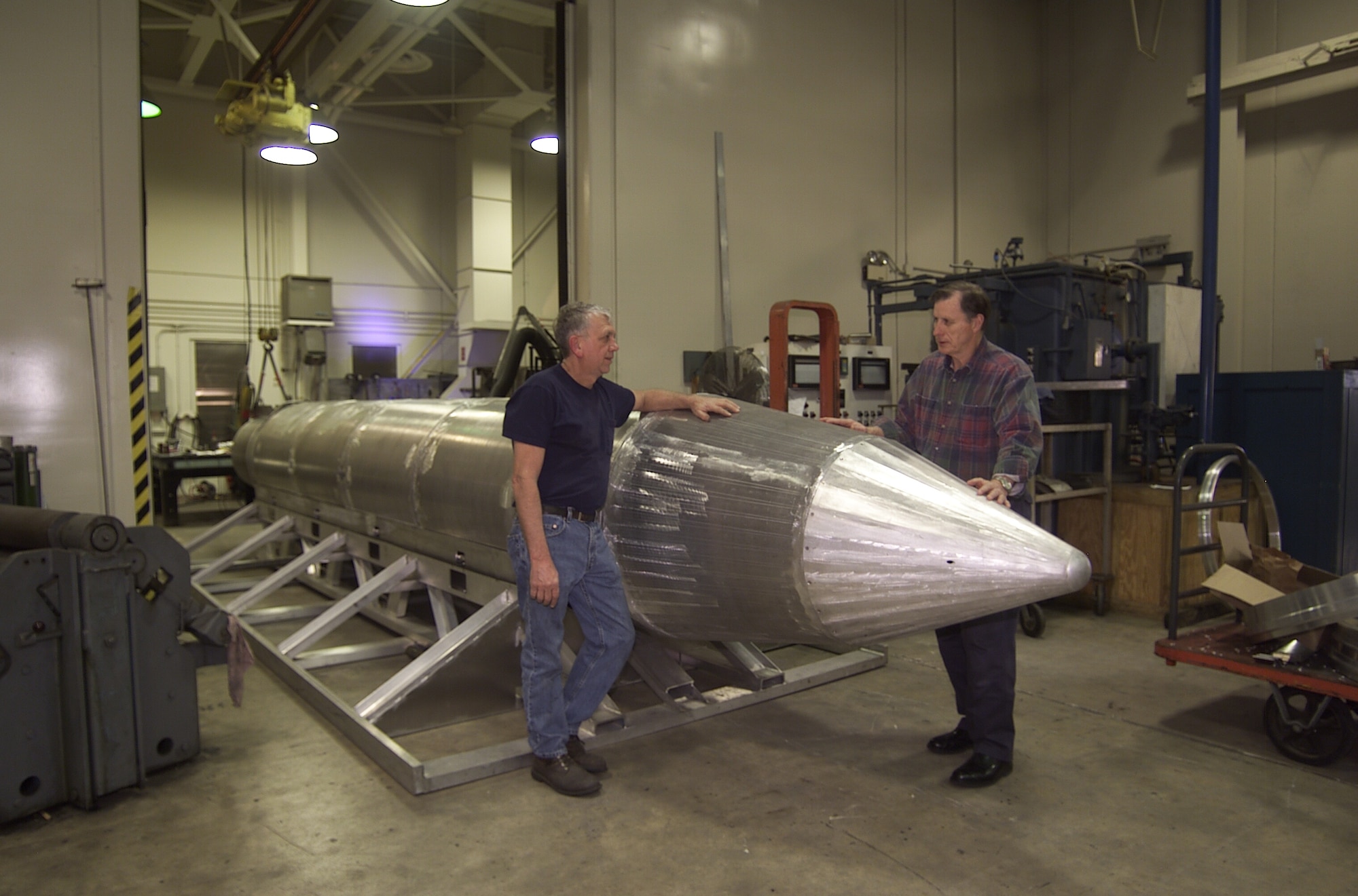 EGLIN AIR FORCE BASE, Fla. -- Al Weimorts, the creator of the GBU-43/B Massive Ordnance Air Blast bomb, left, and Joseph Fellenz, lead model maker look over the prototype before it was painted and tested. (Courtesy photo) 
