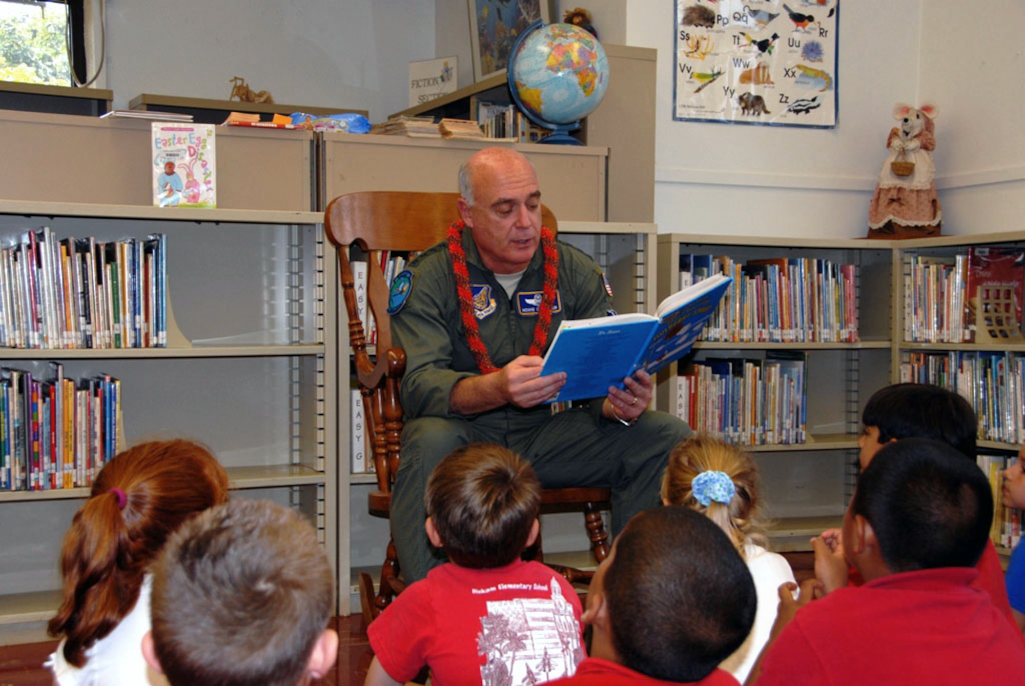 General Carrol H. “Howie” Chandler, Pacific Air Forces commander, reads for a first grade class at Hickam elementary school during The National Education Association’s ‘Read Across America’ program on Mar. 10. The annual event is a reading motivation and awareness program that calls for every child in every community to celebrate reading on or around Dr. Seuss's birthday. Motivating children to read is an important factor in student achievement and creating lifelong successful readers. Research has shown that children who are motivated and spend more time reading do better in school. (U.S. Air Force photo/Tech. Sgt. Justin Huett)