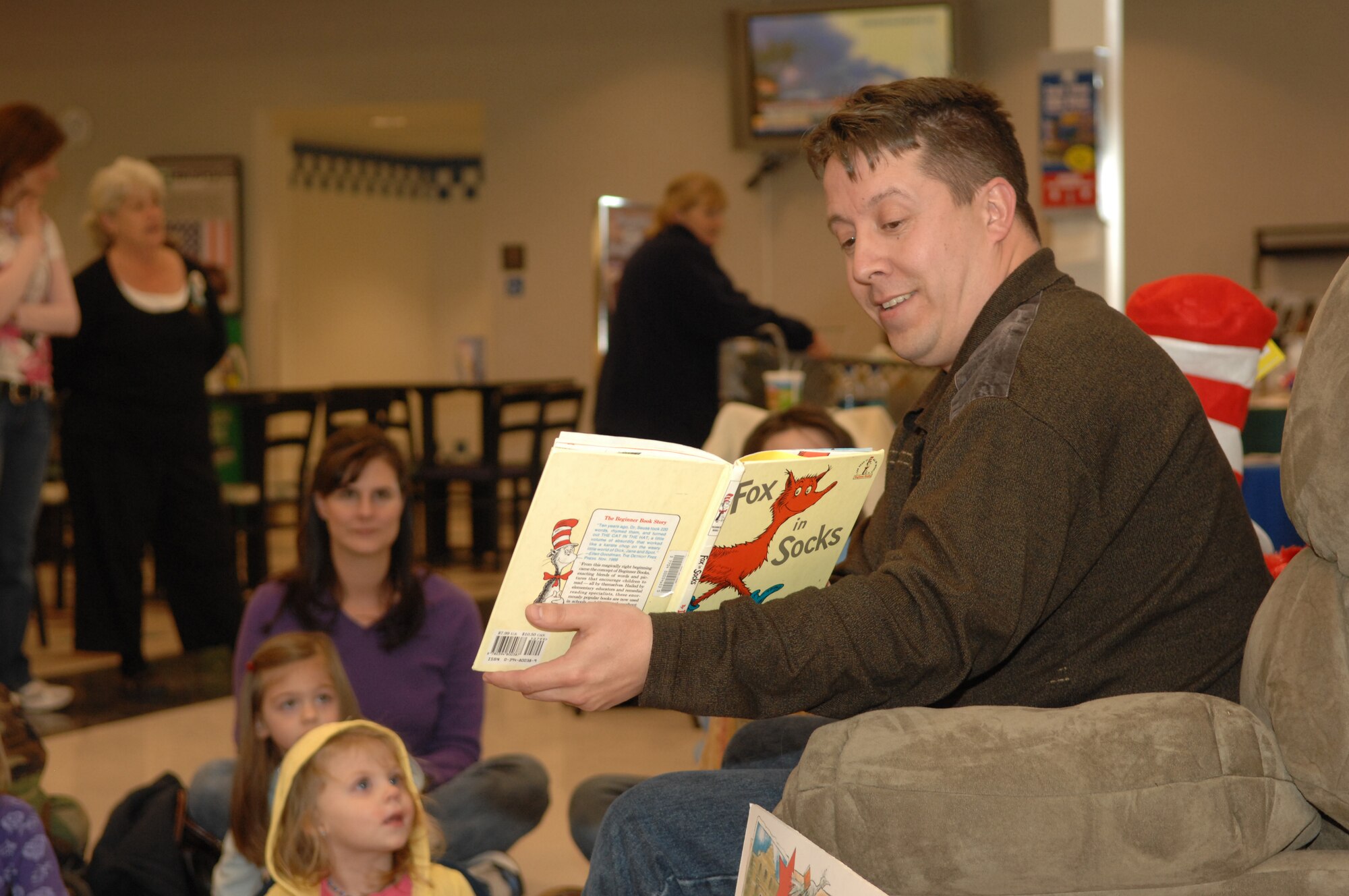DYESS AIR FORCE BASE, Texas -- Master Sgt. Terry Montrose reads to children in the BX March 11. The series was called Return of Cat in the Hat. (U.S. Air Force photo by Airman 1st Class Stephen Reyes)