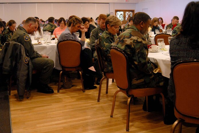 Team Malmstrom members bow their heads in prayer prior to the start of the National Prayer Luncheon at the Grizzly Bend Club March 5. Chaplain (Col.) Brian Hunter, Air Force Space Command chaplain, was the guest speaker. (U.S. AIr Force photo/John Turner)
