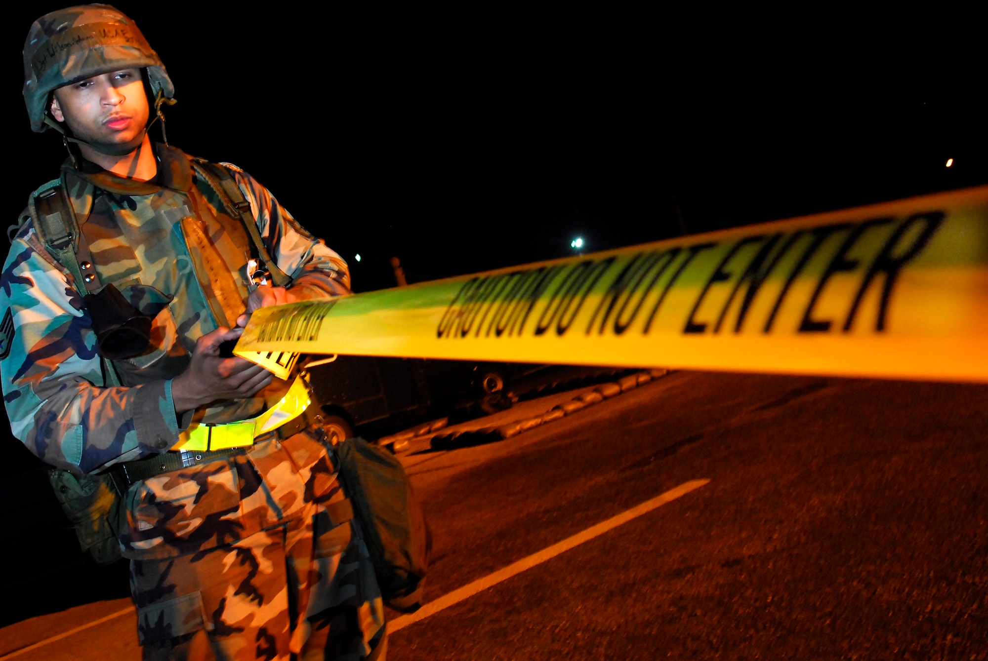 Staff Sgt. Adam Wilson, 18th Logistics Readiness Squadron, sets up a cordon after sweep team found an improvised explosive device located by a sweep team during the 2008 Pacific Air Forces Operational Readiness Inspection at Kadena Air Base, Japan, March 12, 2008. PACAF conducted the inspection from March 9 to 15 to validate mission readiness of the 18th Wing. (U.S. Air Force photo/Staff Sgt. Joshua J. Garcia)