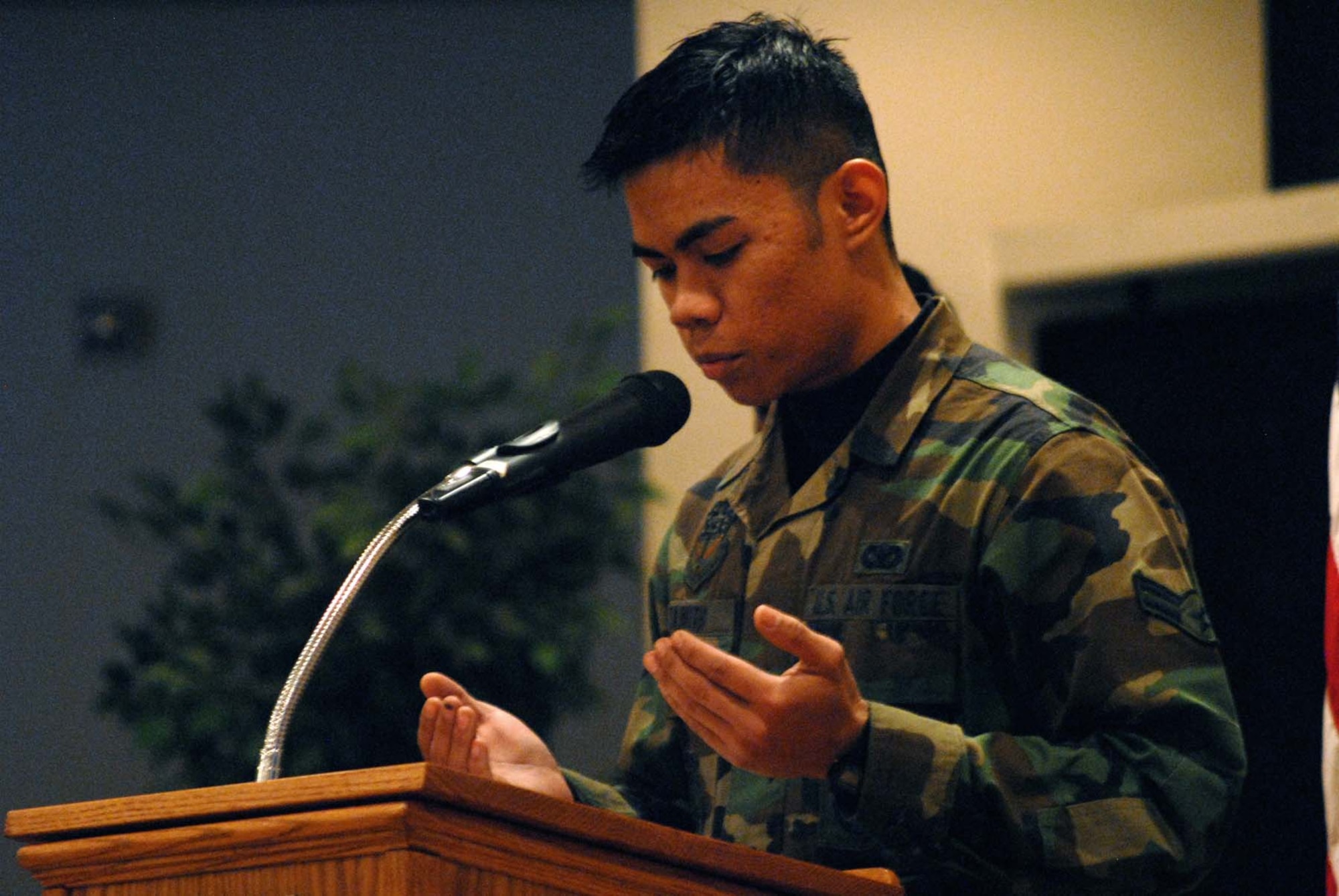 Airman 1st Class Yohan Tawith, 341st Security Forces Squadron, reads from the Qu'ran, prior to the introduction of guest speaker Chaplain (Col.) Brian Hunter, Air Force Space Command chaplain, at the National Prayer Luncheon March 5. (U.S. Air Force photo/John Turner) 