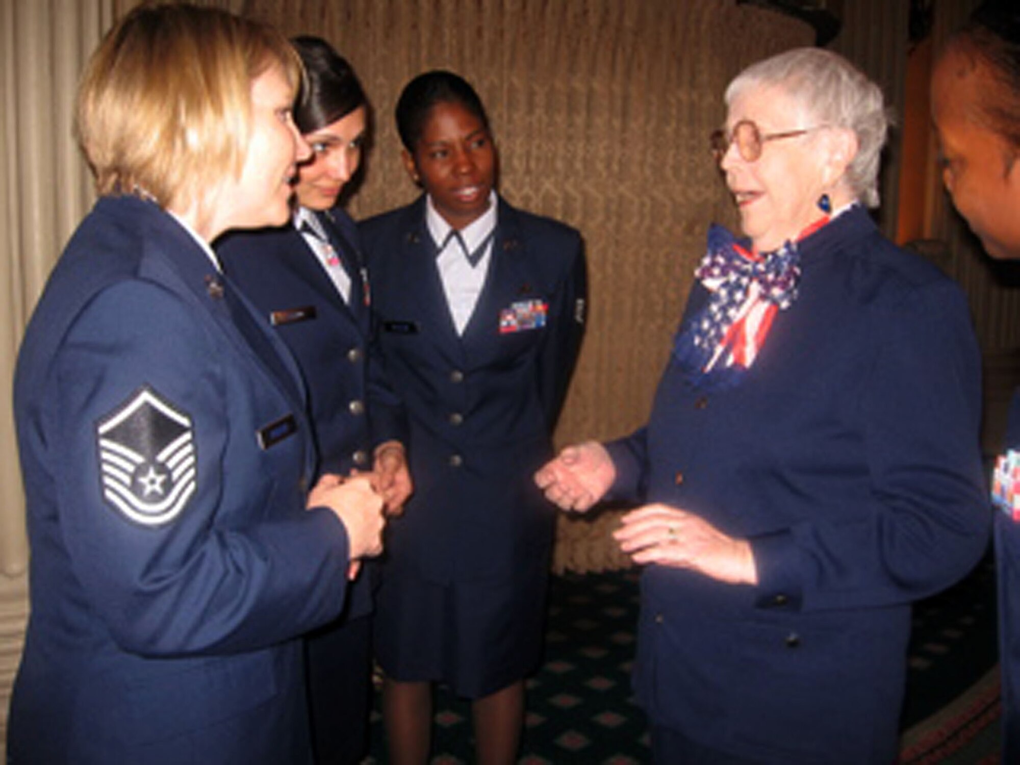 LOS ANGELES -- Edwards Airmen talk to Flora Belle Reece (right), Women Airforce Service Pilots veteran, during the Los Angeles County Commission for Women's "Women of the Year" awards luncheon March 10 at the Millennium Biltmore Hotel in Los Angeles. Five Air Force women from Edwards who recently returned from Iraq and Afghanistan deployments attended the event and led the luncheon participants in reciting the Pledge of Allegiance. (Air Force photo by Lt. Col. Sandy Burr)
