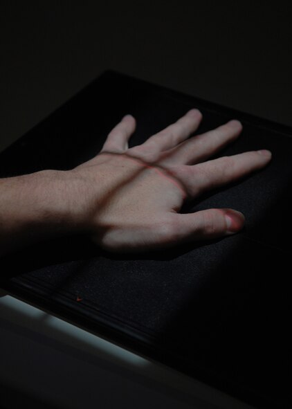 DYESS AIR FORCE BASE, Texas -- Staff Sgt. Trevor Blackburn, a diagnostic imagining technologist, places his hand on a table for X-ray training March 10. (U.S. Air Force photo by Airman 1st Class Jennifer Romig)