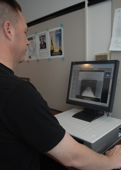 DYESS AIR FORCE BASE, Texas -- Staff Sgt. Trevor Blackburn looks over a digital copy of an X-ray March 10. (U.S. Air Force photo by Airman 1st Class Jennifer Romig)