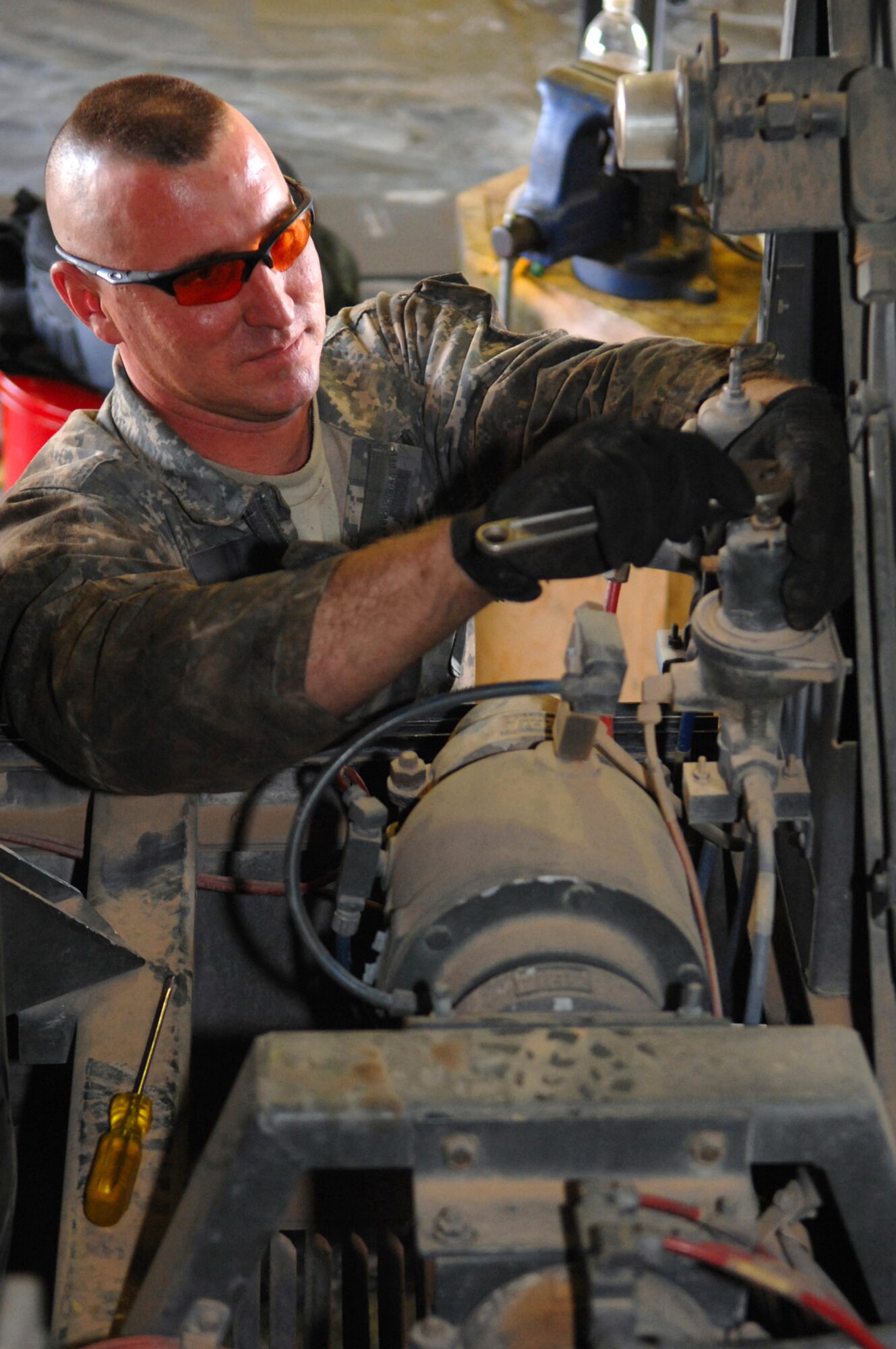Staff Sgt. Jason Jablonowski adjusts the pilot flow pressure for aircraft fuel March 8 at Balad Air Base, Iraq. The pilot flow controls the rate at which fuel is pumped into an aircraft. Sergeant Jablonowski, a 332nd Expeditionary Logistics Readiness Squadron refueling truck mechanic, is deployed from Luke Air Force Base, Ariz. (U.S. Air Force photo/Senior Airman Julianne Showalter) 