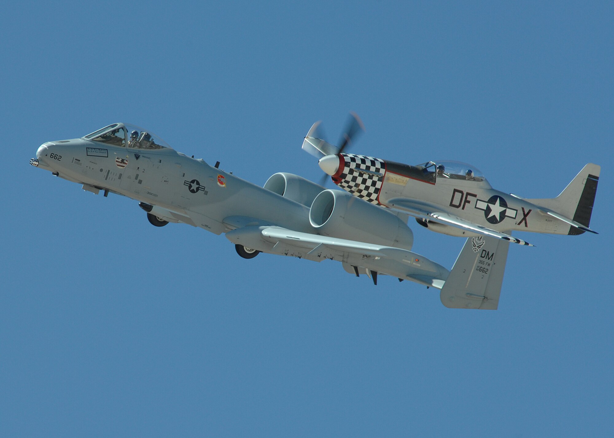 An A-10 Thunderbolt II from the A-10 West Demonstration Team flies in formation with a P-51 Mustang, March 7, at Davis-Monthan AFB, Ariz during the 2008 Heritage Flight Conference. The Heritage Flight Conference allows civilian and military pilots to train together in preparation for the spring and summer air show seasons. (U.S. Air Force photo/Senior Airman Christina D. Kinsey)