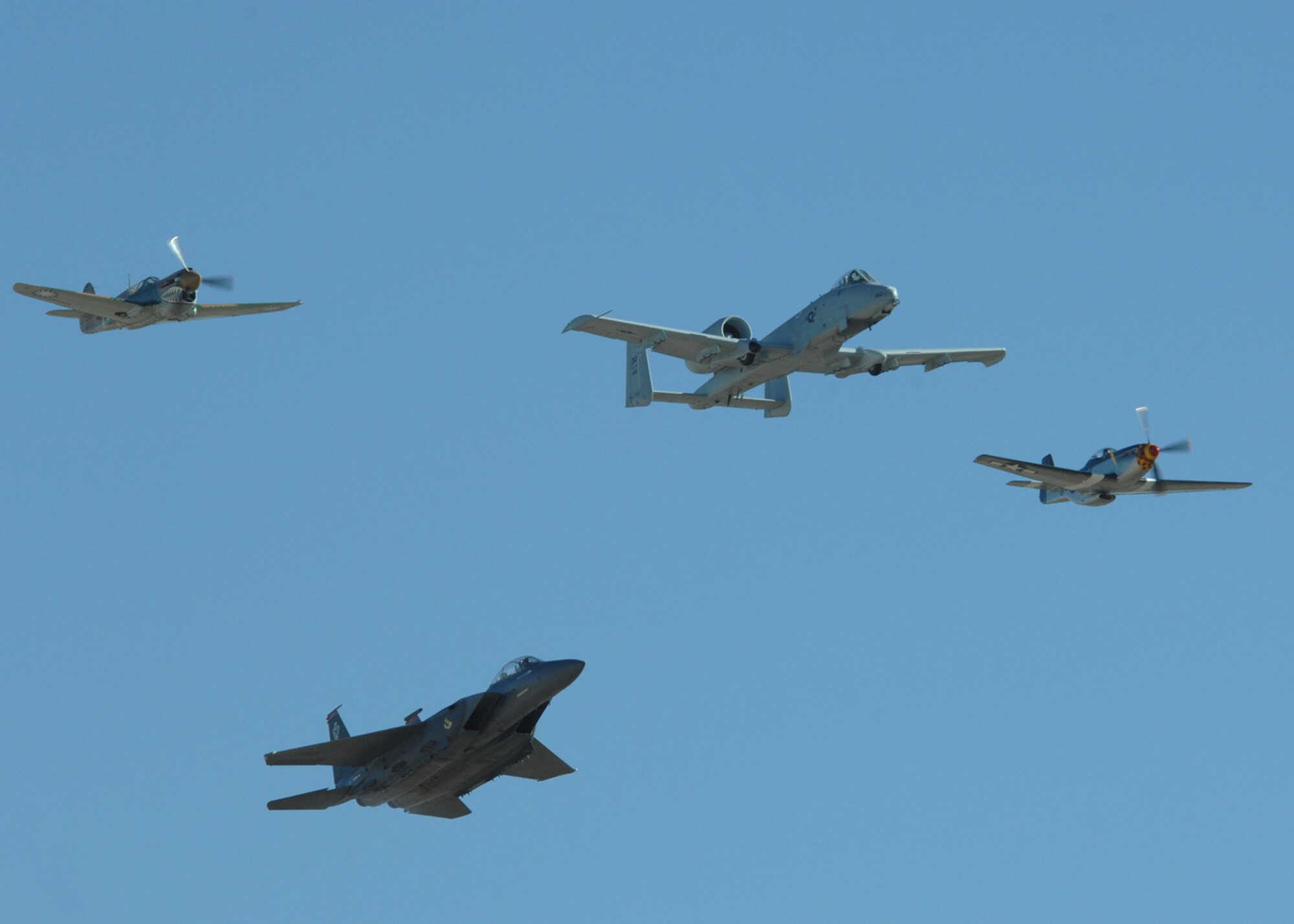 An A-10 Thunderbolt II from the A-10 West Demonstration Team, two P-51 Mustangs, and a F-15 fly in formation during the 2008 Air Combat Command heritage Flight Conference, March 8 at Davis-Monthan AFB, Ariz. The Heritage Conference provides an opportunity for Air Combat Command demonstration pilots to train together with modern and historic military aircraft in preparation for the upcoming air show seasons. (U.S. Air Force photo/Senior Airman Christina D. Kinsey)