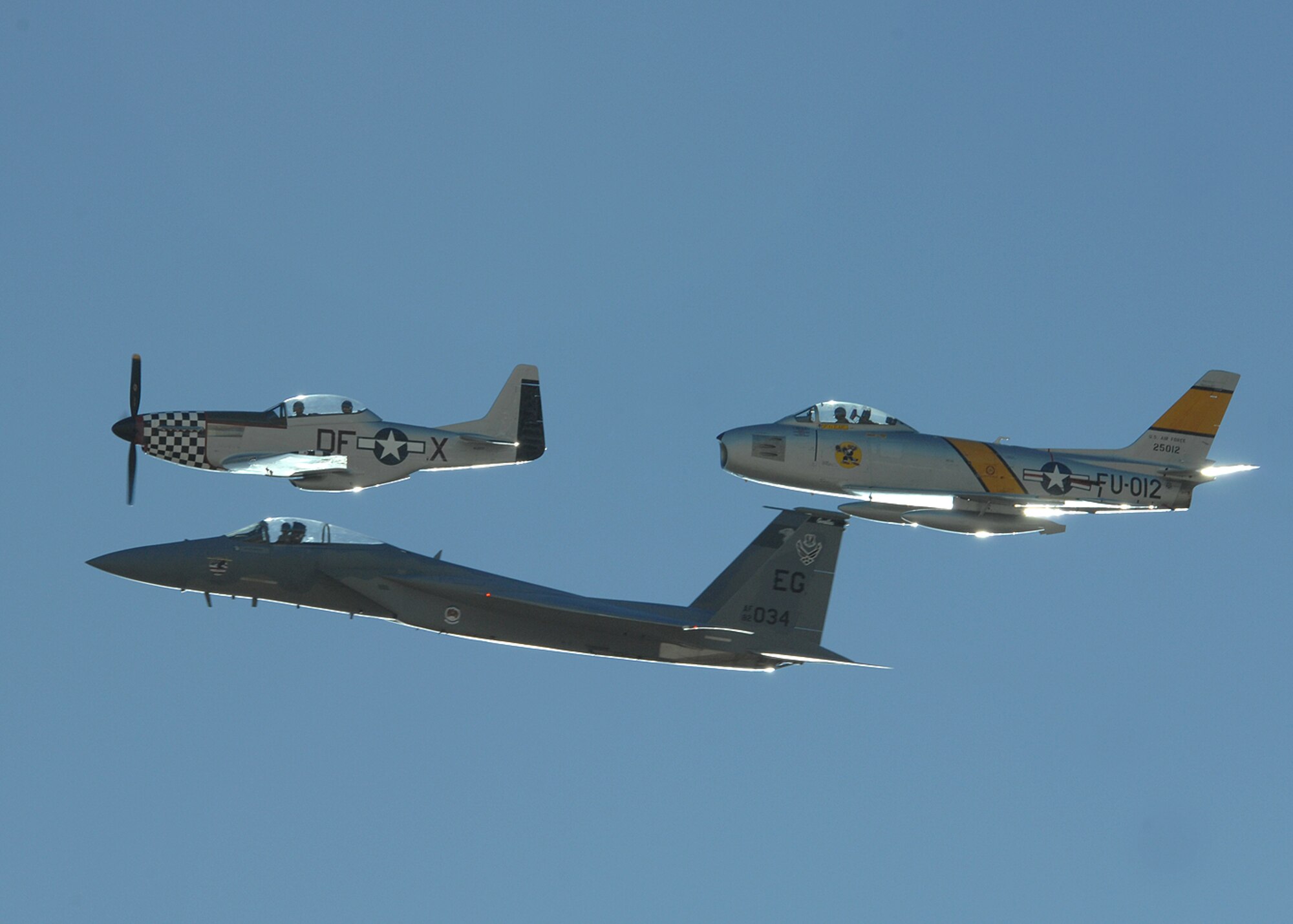 A P-51 Mustang, F-86 Sabre, and a F-15 from the West Coast demonstration team fly in formation during the 2008 Air Combat Command heritage Flight Conference, March 8 at Davis-Monthan AFB, Ariz. The Heritage Conference provides an opportunity for Air Combat Command demonstration pilots to train together with modern and historic military aircraft in preparation for the upcoming air show seasons. (U.S. Air Force photo by Senior Airman Christina D. Kinsey)