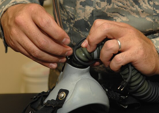 Master Sgt. Charles Ruscetta, 355th Operation Support Squadron, cleans the mask making sure Dr. Robert Shelton can breathe during a flight in an F-15E during the Heritage Flight Conference here March 9. Dr. Robert Shelton received an incentive flight from the base to be able to fly in an F-15E during the conference. (US Air Force photo by Senior Airman Jacqueline Hawkins)
  