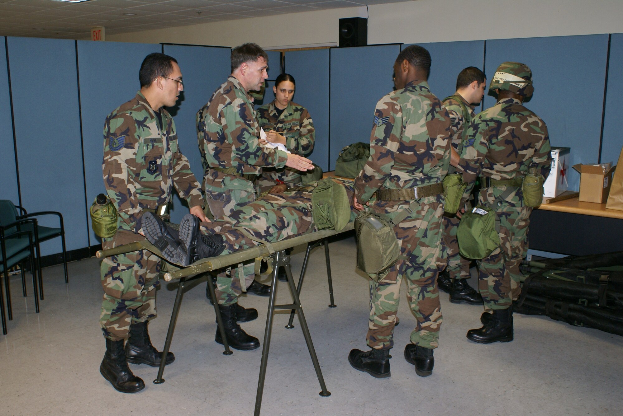 Maj. Phillip Dlugasch, a clinical nurse assigned to the 482nd Medical Squadron, instructs his team medical technicians on proper triage and treatment methods during Operation Deliberate Tropic, Homestead Air Reserve Base, March 11, 2008.  The Operational Readiness Exercise is a self-assessment of the wing’s ability to perform in a simulated combat environment. Explosive devices, smoke grenades and sirens will be used during the exercise to create realistic scenarios that reservists will encounter during the exercise. “Homestead Air Reserve Base goes to great lengths to ensure safety procedures are established and followed during exercises to prepare our reservists for deployment,” said Mr. Sean Quinn, 482nd Mission Support Group Emergency Management Office. (U.S. Air Force photo/Tim Norton)