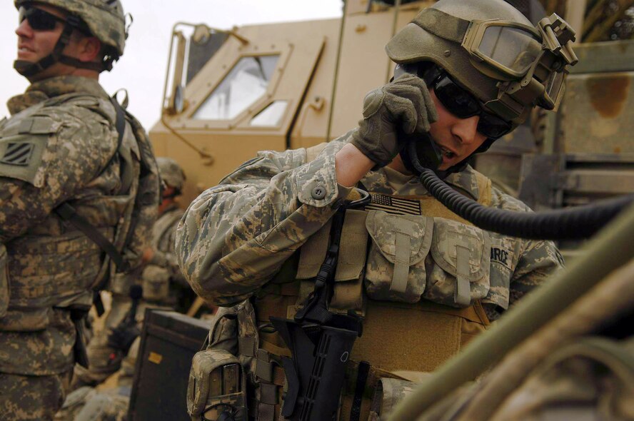 Senior Airman Joseph Aton clears a B-1B Lancer to drop six 500-pound guided bomb unit-38s onto an al-Qaida torture house and prison March 10 in northern Zambraniyah, Iraq. Airman Aton is a joint terminal attack controller from Fort Hood, Texas, and is deployed with the 2nd Brigade Combat Team, 3rd Infantry Division. (U.S. Air Force photo/Master Sgt. Andy Dunaway)
