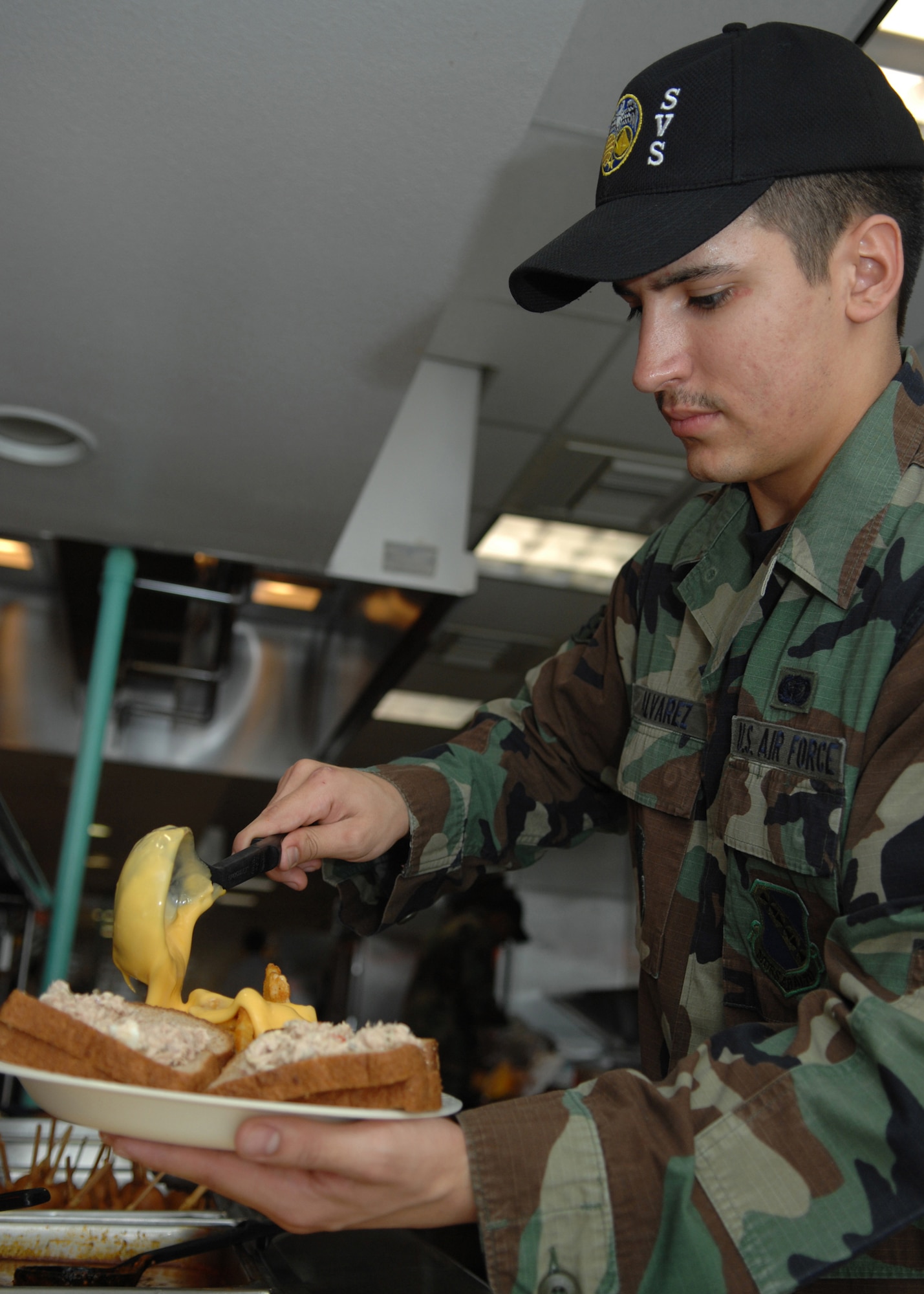 DYESS AIR FORCE BASE, Texas -- Airman 1st Class Joshua Alvarez, 7th Services Squadron,serves lunch March 10. (U.S. Air Force photo by Airman 1st Class Jennifer Romig)