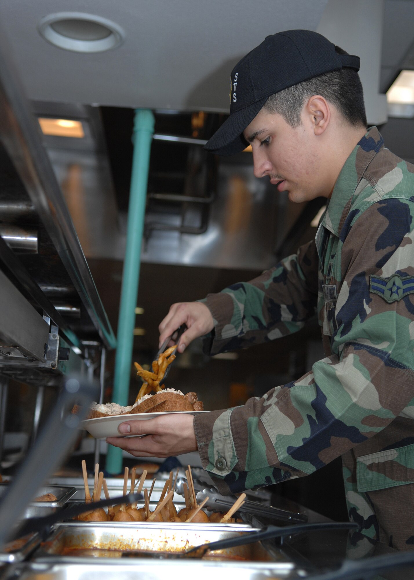 DYESS AIR FORCE BASE, Texas --Airman 1st Class Joshua Alvarez, 7th Services Squadron, serves lunch March 10. (U.S. Air Force photo by Airman 1st Class Jennifer Romig)