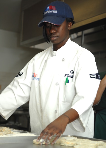 DYESS AIR FORCE BASE, Texas -- Airman 1st Class Britney Robinson, 7th Services Squadron, makes cheese biscuits as part of March 10 lunch menu. (U.S. Air Force photo by Airman 1st Class Jennifer Romig)