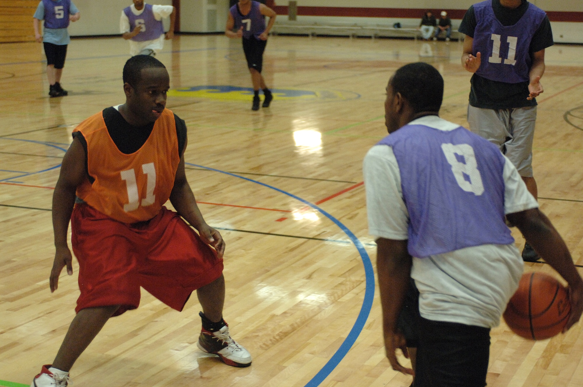 Preston Winn #11, 28th Logistics Readiness Squadron small forward, defends Derek Walton #8, 28th Security Forces Squadron point guard, in the Ellsworth intramural championship game March 6. Security forces won the base championship in overtime with a final score of 79-71. (U.S. Air Force photo by Airman Corey Hook)  