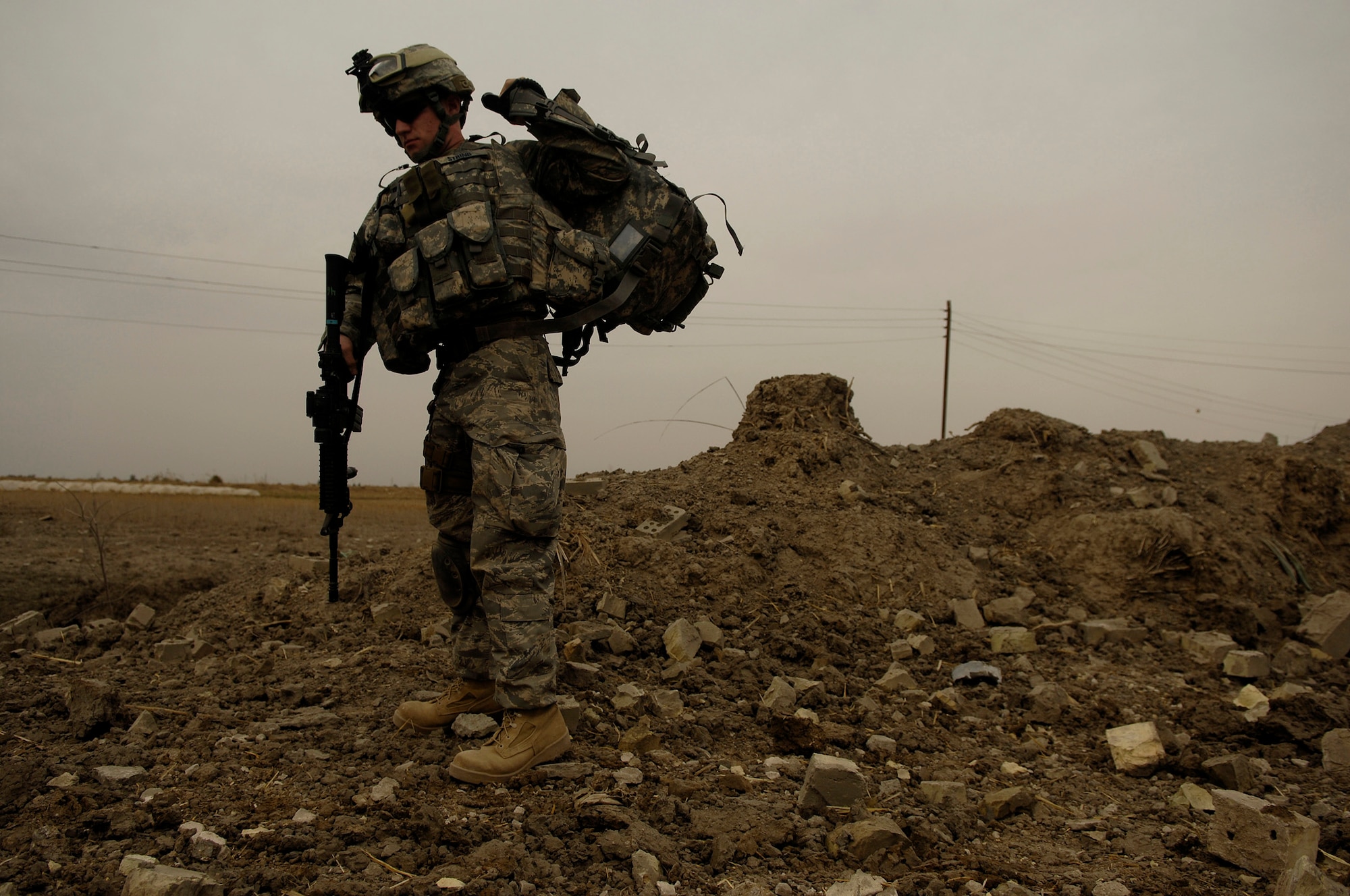 U.S. Air Force Airman First Class Daniel String puts his radio and gear on after a B-1B Lancer successfully dropped six GBU-38 munitions onto an al-Qaede in Iraq torture house and prison in northern Zambraniyah, Iraq, Mar., 10 2008. Airman Aton is a Joint Terminal Attack Controller is from Fort Drum N.Y., and is deployed with the 3rd Infantry Division 2nd Brigade. (U.S. Air Force photo by Master Sgt. Andy Dunaway) (Released)
