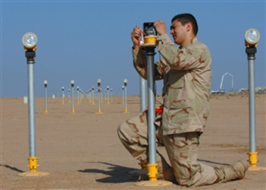 U.S. Air Force Airman Nicholas Wengerd trouble shoots a strobe approach light on the runway at Balad Air Base, Iraq, Feb. 28, 2008.  Wengerd is an electrician with 332nd Expeditionary Civil Engineer Squadron.  