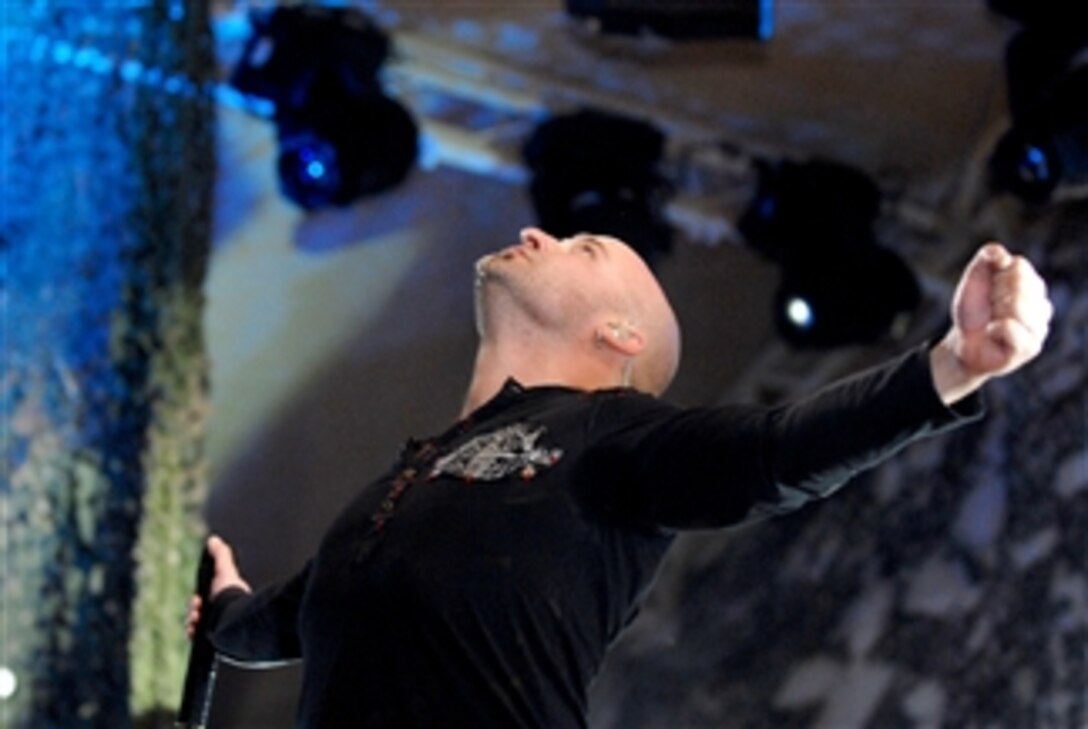 David Draiman, vocalist for the band Disturbed, sings to a crowd of about 5,000 troops at Camp Buehring, Kuwait, March 10, 2008. MySpace, the social networking Web site, presented a concert for the troops with the cooperation of Armed Forces Entertainment and the Defense Department’s “America Supports You” program. 