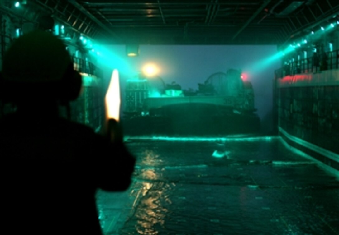 A U.S. sailor guides a landing craft air cushion into the well deck of USS San Antonio while under way in the Atlantic Ocean, March 9, 2008. 