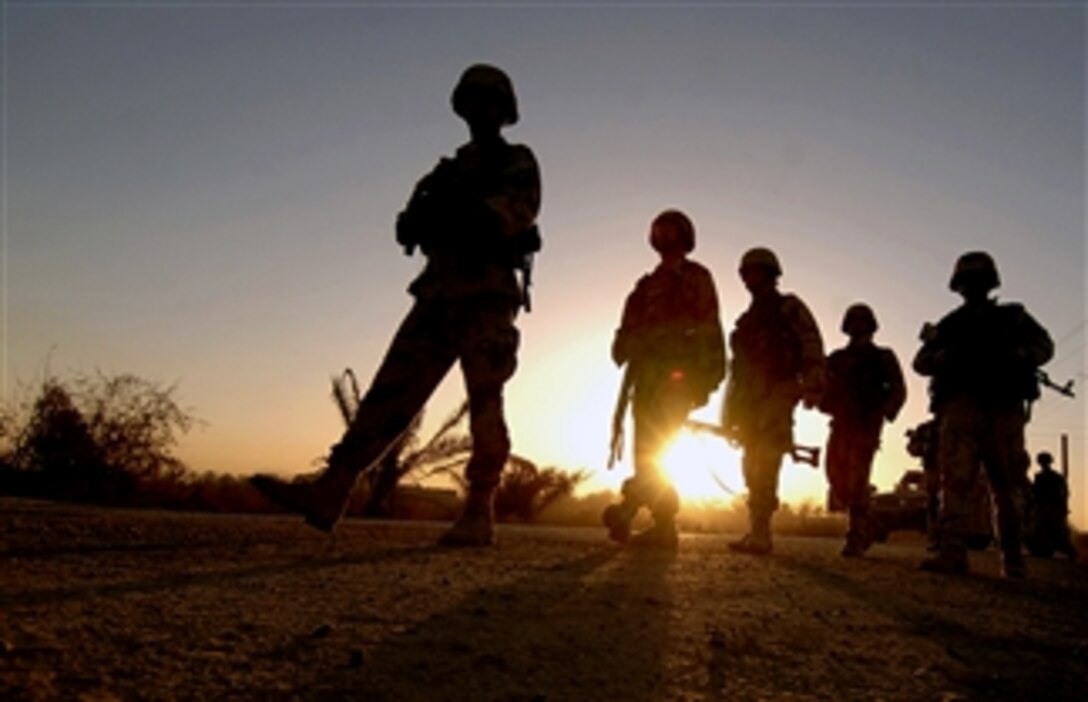 Iraqi soldiers walk down a road leading into Ali Shaheen, Iraq, March 7, 2008, to begin a clearing operation. They are assigned to the 8th Iraqi Army Division's 32nd Infantry Brigade, 2nd Battalion.
 
