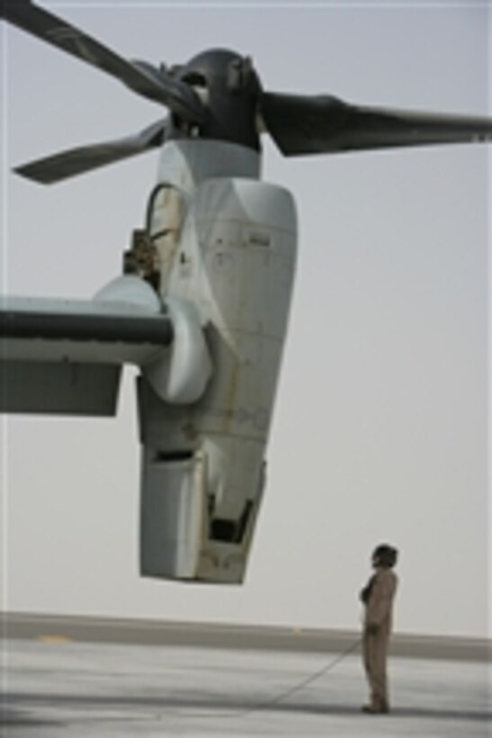 U.S. Marine Corps Sgt. Danny L. Herrman watches the start-up of the port engine on an MV-22B Osprey aircraft on the flight line at Al Asad, Iraq, on March 5, 2008.  Herrman is a crew chief with Marine Medium Heavy Tiltrotor Squadron 263, which is deployed as a part of Multi-National Force - West in support of Operation Iraqi Freedom.  