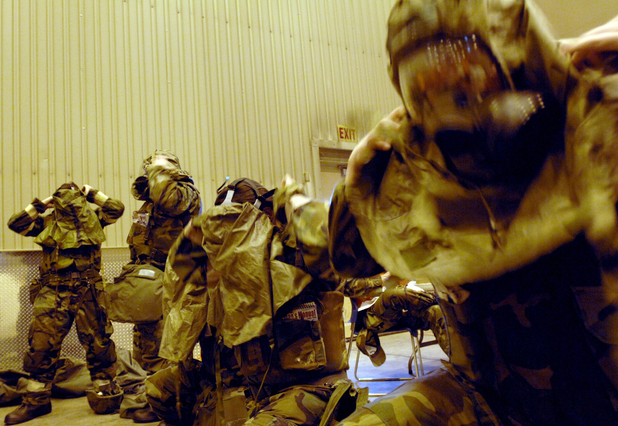 Airman First Class Christopher Matlock (right) along with other members of the 354th Fighter Wing hurry to don their gas masks  within the 15 second time limit while being evaluated during the Ability To Survive and Operate (ATSO) portion of the Golden Raven Operational Readiness Exercise on March 9, 2008 at Eielson Air Force Base, Alaska.  The Golden Raven Operational Readiness Exercise is an evaluation of the 354th Fighter Wing's ability to prepare and deploy personnel, equipment and support assets to a combat environment. The exercise consists of four graded areas: initial response and deployment, employment, ability to survive and operate (ATSO) and combat response.

(U.S Air Force photo by Staff Sgt. Eric T. Sheler)

