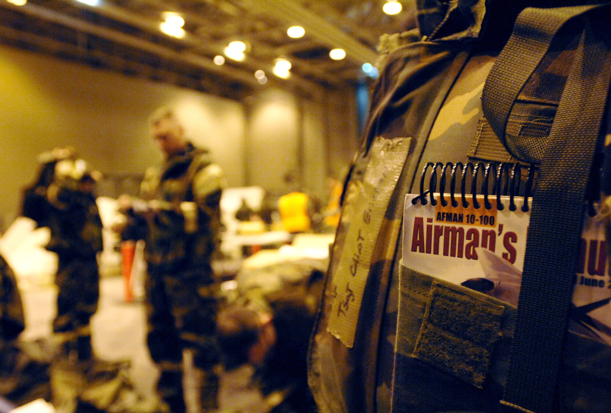 Air Force Manual 10-100 has essential knowledge of surviving techniques and other information to make U.S Air Force members effective during combat. All Airmen are required to carry their manual during deployments and deployment exercises. U.S Air Force Technical Sgt. Clint Ericson fulfills his requirement by having his Air Force manual 10-100 with him during Exercise GOLDEN RAVEN 08-02, an operational readiness exercise March 9, 2008 here.  The GOLDEN RAVEN is an evaluation of the 354th Fighter Wing's ability to prepare and deploy personnel, equipment and support assets to a combat environment. The exercise consists of four graded areas: initial response and deployment, employment, ability to survive and operate (ATSO) and combat response.

(U.S Air Force photo by Staff Sgt. Eric T. Sheler)

