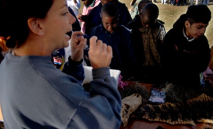 Fifth-graders from Goodwin Elementary School learn about reptiles and their behavior from Kelly Smith, the curator at Cypress Garden in Monks Corner during the Earth Day celebration on base Wednesday. (U.S. Air Force photo/Senior Airman Nicholas Pilch)