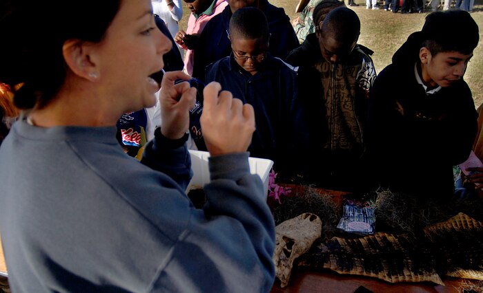 Fifth-graders from Goodwin Elementary School learn about reptiles and their behavior from Kelly Smith, the curator at Cypress Garden in Monks Corner during the Earth Day celebration on base Wednesday. (U.S. Air Force photo/Senior Airman Nicholas Pilch)