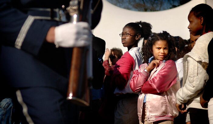 A young girl looks at the Charleston AFB Honor Guard as they pass the crowd during the Earth Day celebration on base Wednesday. (U.S. Air Force photo/Senior Airman Nicholas Pilch)