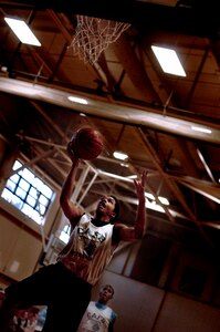 Tevin Wadley lays the ball up during the state championship game at the base gym Saturday. Tevin, the 16-year-old son of Lenelle Reid, plays on the Charleston AFB Blue youth basketball team. (U.S. Air Force photo/Senior Airman Nicholas Pilch)