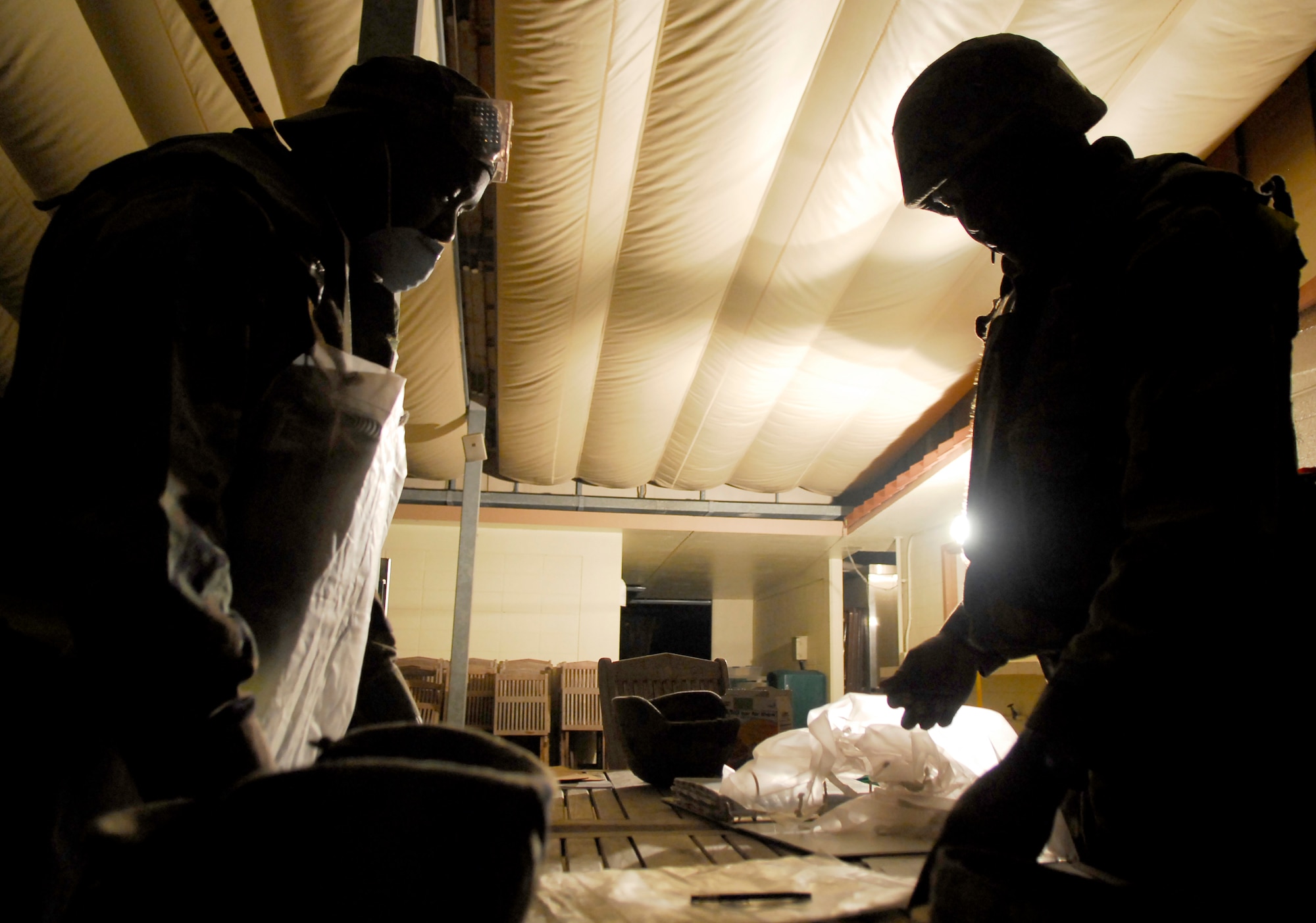 Tech. Sgt. Anthony Long and Staff Sgt. Harron Wilson, both with the 18th Services Squadron, review paperwork after processing a casualty during the 2008 Pacific Air Forces Operational Readiness Inspection at Kadena Air Base, Japan, March 13, 2008. PACAF conducted the inspection from March 9 to 15 to validate mission readiness of the 18th Wing. (U.S. Air Force photo/Staff Sgt. Joshua J. Garcia)